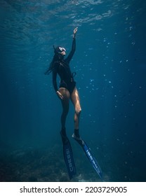 Panglao, Philippines - 21.08.2022: Female Freediver Fun Diving In The Ocean Sea Holding Breath