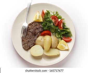 Pan-grilled pepper minute steak served with a salad of fresh leaves, tomato, cucumber and lemon with boiled new potatoes