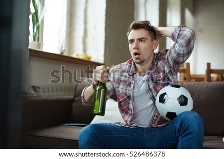 Similar – Image, Stock Photo Anxious men watching game over mobile phone at home