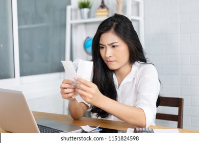 The Panic Asian Woman Checking Expensive Electricity And House Hold Bills, Reads Documents Attentively, Prepares Financial Report, Calculates On Laptop Computer. Finance Interior,domestic Housework