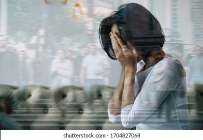 Panic attack. Close-up photo of a woman who is hiding her face with her hands and crying because of her social anxiety. Double exposure photo.