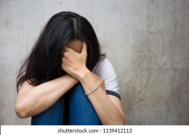 panic attacks young girl in sad and fear stressful depressed emotional.sitting and cry use hands cover face begging for help.concept for stop abusing violence in women,human rights,person with anxiety