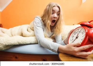 Panic Woman Waking Up Late In Morning Turning Off Alarm Clock. Young Girl Laying In Bed.