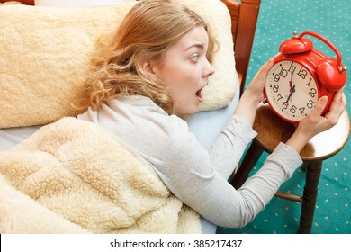 Panic Woman Waking Up Late In Morning Turning Off Alarm Clock. Young Girl Laying In Bed.