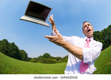 Panicked Businessman Running Away From A Flying Laptop Computer