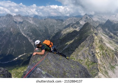 Panicked Person During Dangerous And Exposed Mountain Climb