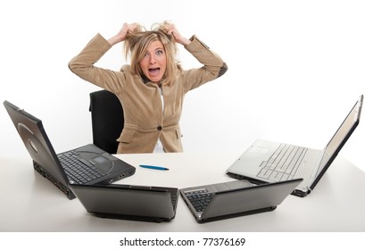 Panicked Young Woman In Front Of Four Laptops