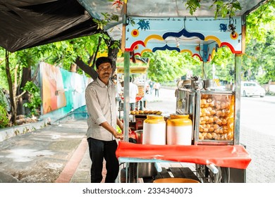 panipuri shop -happy young male Indian roadside vendor selling golgappe