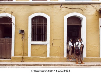 PANJIM, INDIA - FEB 25: Schoolgirls In Uniform Talking In Front Of Old School Building In Historical Indian Town On February 25, 2017. Near 5 Million Tourists Visit Goa Annually