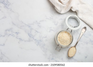 Panko Japanese Crispy Breadcrumbs In A Glass Jar On A Marble Background Close-up. A Crumb For Cooking . Selective Focus, Top View, Copy Space