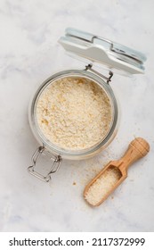 Panko Japanese Crispy Breadcrumbs In A Glass Jar On A Marble Background Close-up. A Crumb For Cooking . Selective Focus, Top View, Copy Space