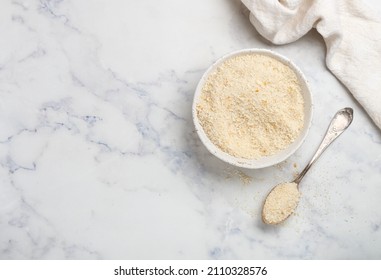 Panko Japanese Crispy Breadcrumbs In A White Plate On A Marble Background Close-up. A Crumb For Cooking . Selective Focus, Top View, Copy Space