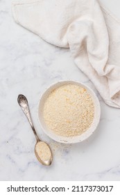 Panko Japanese Crispy Breadcrumbs In A White Plate On A Marble Background Close-up. A Crumb For Cooking . Selective Focus, Top View, Copy Space