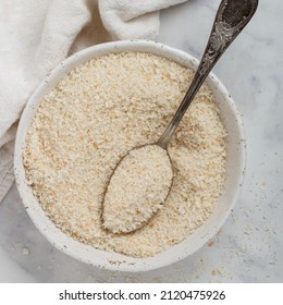 Panko Japanese Crispy Breadcrumbs In A White Plate On A Marble Background Close-up. A Crumb For Cooking . Selective Focus, Top View, Copy Space, Square Picture