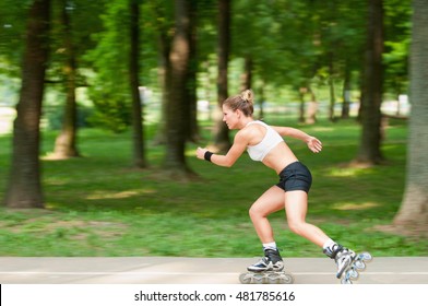 Panning Image Of Fast Moving Young Woman On Roller Blades