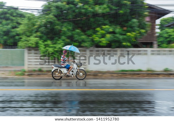 Panning,Drive rain,Driving car in the\
street hit by the heavy rain , in motion blur,rainy spring,Driving\
dangerous motor vehicles,30-May-2019, Lampang,\
Thailand.