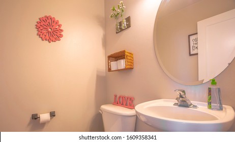 Pano Bathroom Interior With Toliet Adjacent To Stand Alone Sink And Round Mirror