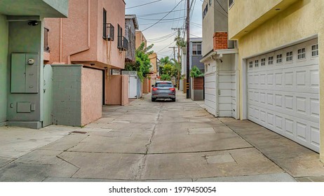 Pano Car On A Narrow Neighborhood Street Along Houses In Long Beach California. Electricity Posts Line The Road And Cloudy Sky Is Overhead.