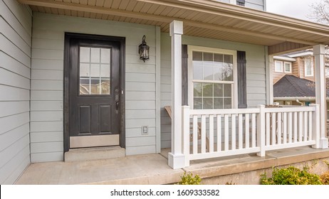 Pano Exterior Of Home With Glass Panels On Front Door And Stairs Going To The Porch