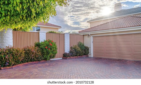 Pano Garage and driveway inside fence and gate of Huntington Beach California home