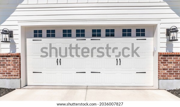 Pano Garage entryway exterior with wall mounted\
lamp on both sides