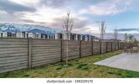 Pano Home Backyard With Patio Chairs Overlooking The Valley And Snow Capped Mountain. Grassy Lawn, Steps, Sliding Glass Door And Woode Fence Can Also Be Seen At The House Exterior.