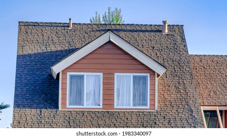 Pano Home Facade In San Diego California With Dormers And Garage Against Blue Sky. Sunny Day Scenery Of House Exterior With Pitched Roof At A Coastal Neighborhood.