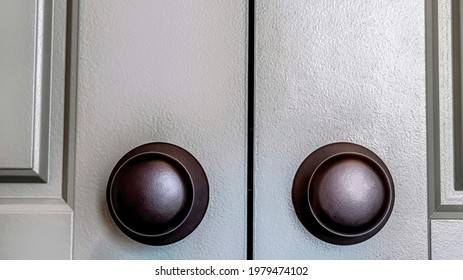 Pano Shiny Round Black Doorknobs Installed On The Wooden Panelled Double Doors. Close Up Of A Hinged Interior Door At The Bedroom Entrance.