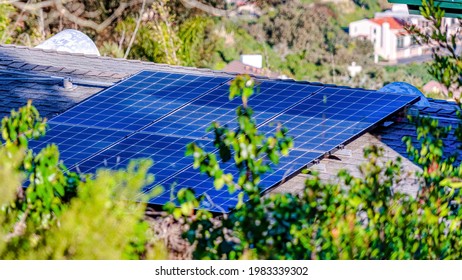 Pano Solar Panels On The Roof Of House In San Diego California Against Green Foliage. Aerial View Of A Home Against A Coastal Landscape Scenery On A Sunny Day.