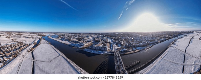 Panorama 180 degrees ready for VR and steel draw bridge over river IJssel   white floodplains Dutch Hanseatic medieval tower town Zutphen  The Netherlands  Aerial cityscape after snowstorm 