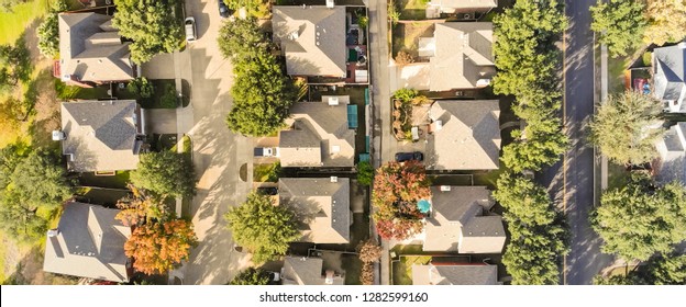 Panorama aerial drone view row of single-family detached house in residential area with colorful autumn leaves. Straight down view of suburban subdivision near Dallas, Texas, USA