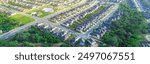 Panorama aerial urban sprawl suburban neighborhood subdivision long row of new development two story houses, community swimming pool, cul-de-sac keyhole shape dead-end street East of San Antonio. USA