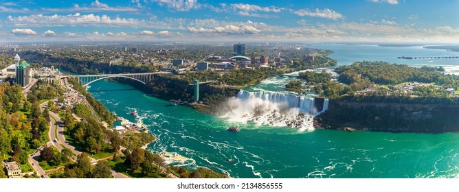 Panorama of aerial view of Canadian side view of Niagara Falls, American Falls and Rainbow International Bridge in Niagara Falls, Ontario, Canada