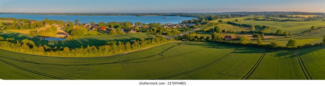 Panorama aerial view of idyllic countryside with blue lake, Hüttener Berge, Schleswig-Holstein, Germany. The idyllic landscape in the lake district Wittensee and the nature park Hüttener Berge. - Shutterstock ID 2176954801