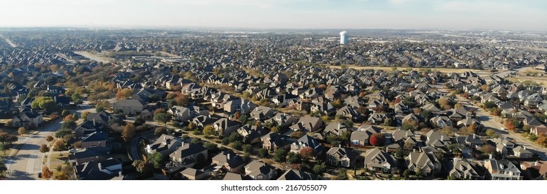 Panorama Aerial View Row Of New Development Two Story Houses With White Water Tower And Colorful Fall Foliage In Cedar Hill, South Of Dallas, Texas, USA. Suburban Home With Large Backyard Fence