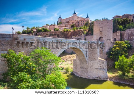 Panorama of the alcazar above the medieval San Martin bridge - Toledo, Spain