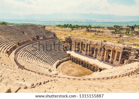 Panorama ancient Greco Roman city. Ruins of ancient city of old amphitheater, Hierapolis in Pamukkale, Turkey. Ruined ancient city in Europe. Is popular tourist destination in Turkey