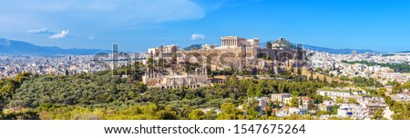 Panorama of Athens with Acropolis hill, Greece. Famous old Acropolis is top landmark of Athens. Skyline of Athens city, landscape with Greek ruins. Scenic panoramic view of remains of ancient Athens.