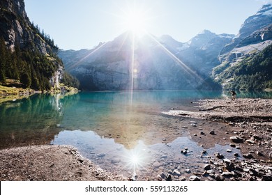 Panorama of the azure pond Oeschinensee. Popular tourist attraction. Picturesque and gorgeous scene. Location Swiss alps, Kandersteg, Bernese Oberland, Europe. Instagram toning effect. Beauty world.