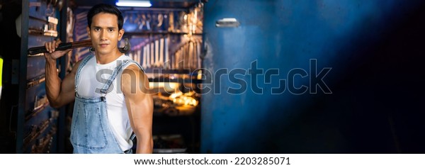 Panorama banner background.\
Portrait young asian male mechanic engineering working on Vehicle\
in a Car Service. Repair service specialist, technical\
maintenance