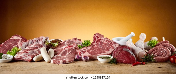 Panorama Banner With Large Assortment Of Raw Meat For A BBQ With Beef Steak, Kringelwurst, Sausages, Pork And Chicken Legs Suitable For Butchery Advertising