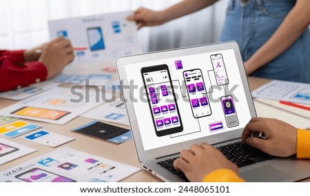 Panorama banner of startup UX developer or company employee design user interface or UI prototype for mobile application or website software with software display on laptop monitor in office. Synergic