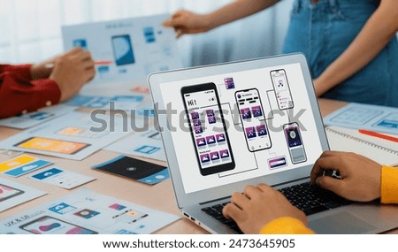 Panorama banner of startup UX developer or company employee design user interface or UI prototype for mobile application or website software with software display on laptop monitor in office. Synergic