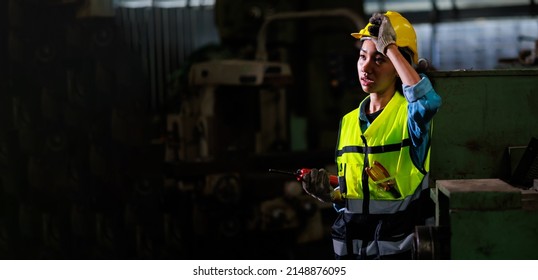 panorama banner. Tired heat and hot. Portrait stress african american female engineer worker wearing safety hard hat helmet at warehouse manufacturing. Metal lathe industrial manufacturing factory.  - Shutterstock ID 2148876095