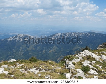 Panorama of beautiful mountain. Sunny day in nature. Wonderful landscape in mountains. grassy field and rolling hills.