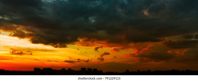 Panorama of a beautiful stormy sunset over the city in dramatic colors - Powered by Shutterstock