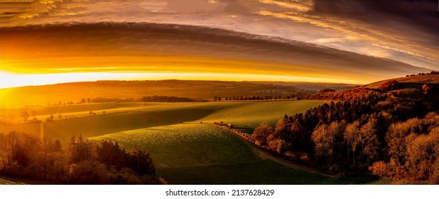 Panorama of a beautiful sunrise over the valley. Beautiful valley panorama at dawn. Sunrise over beautiful valley panoramic landscape - Shutterstock ID 2137628429