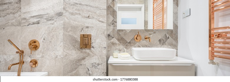 Panorama Of Beige Bathroom With Marble Style Tiles And Golden Taps, Flush And Wall Heater