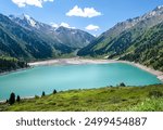 Panorama of Big Almaty Lake in the mountains in summer. Beautiful high-mountain lake not far from Almaty.