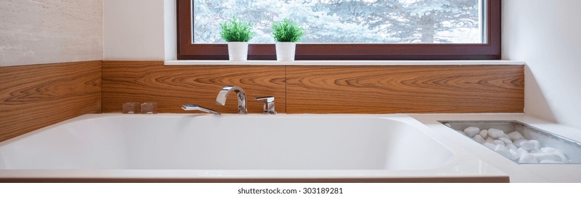 Panorama Of Big Bathtub With Ceramic Wood Imitation Backsplash